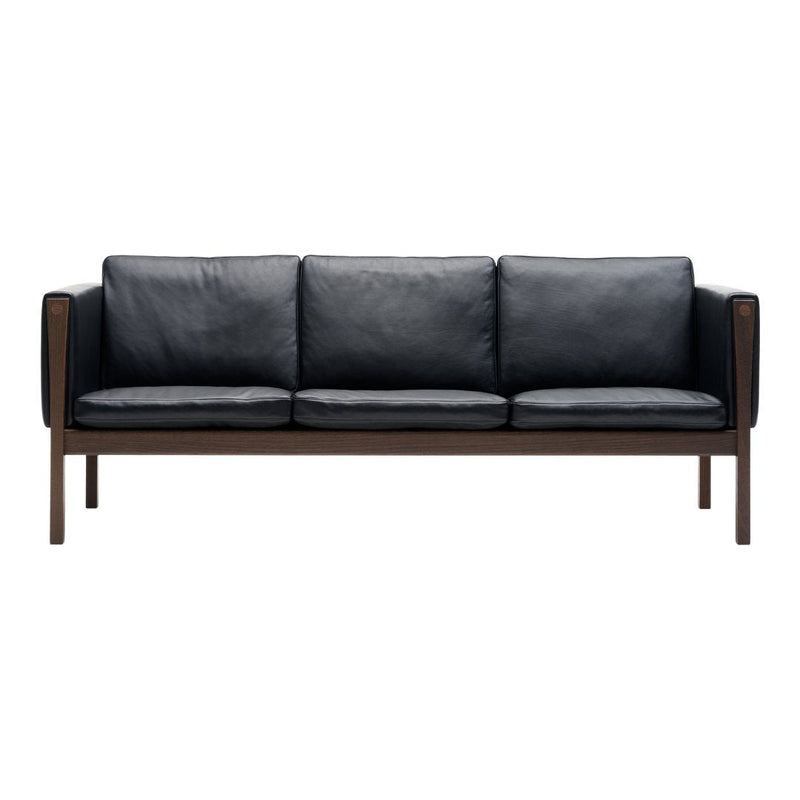 Black leather sofa with a modern wood frame, featuring a sleek and minimalist design. Ideal for contemporary decor.