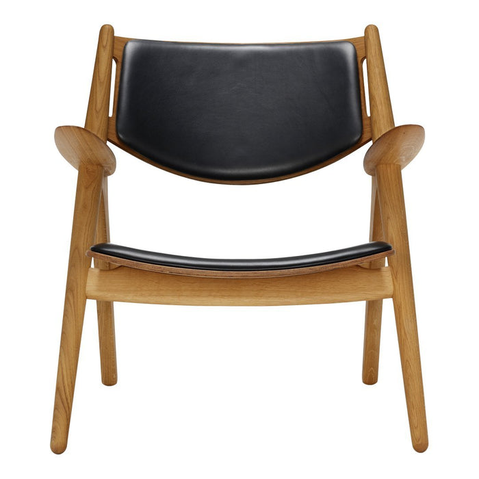 Black leather chair with natural wood frame, featuring a minimalist design and smooth curves. Ideal for modern decor.