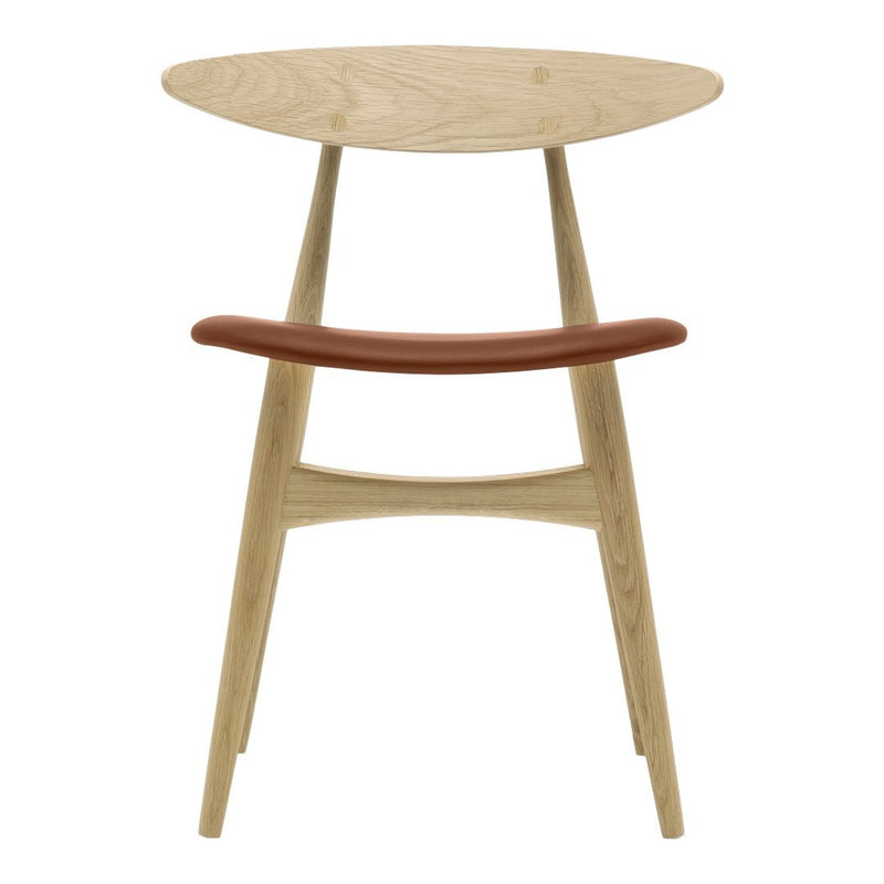 Light wood chair with a smooth, circular top and a curved brown leather accent, showcasing minimalist design.