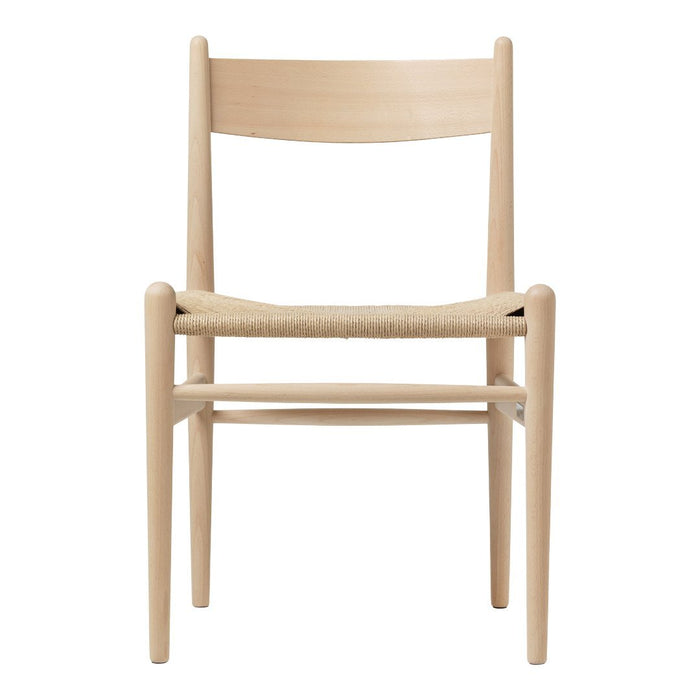 Light wood chair with a natural finish and woven seat, featuring a simple, minimalist design without patterns.