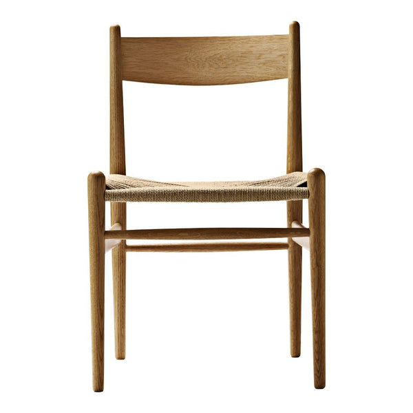 Natural wood chair with a light oak finish and woven beige seat. Minimalist design and clean lines for a modern aesthetic.