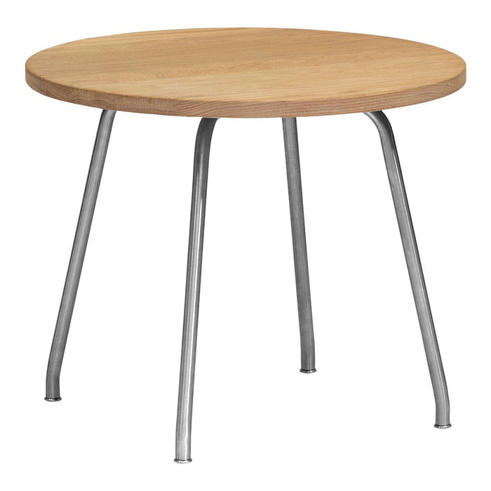 Round wooden table with a light natural wood finish and sleek silver metal legs. Simple, modern design.