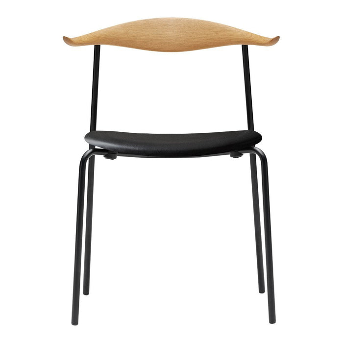 "Natural wood and black metal chair with a sleek curved design, perfect for modern decor."