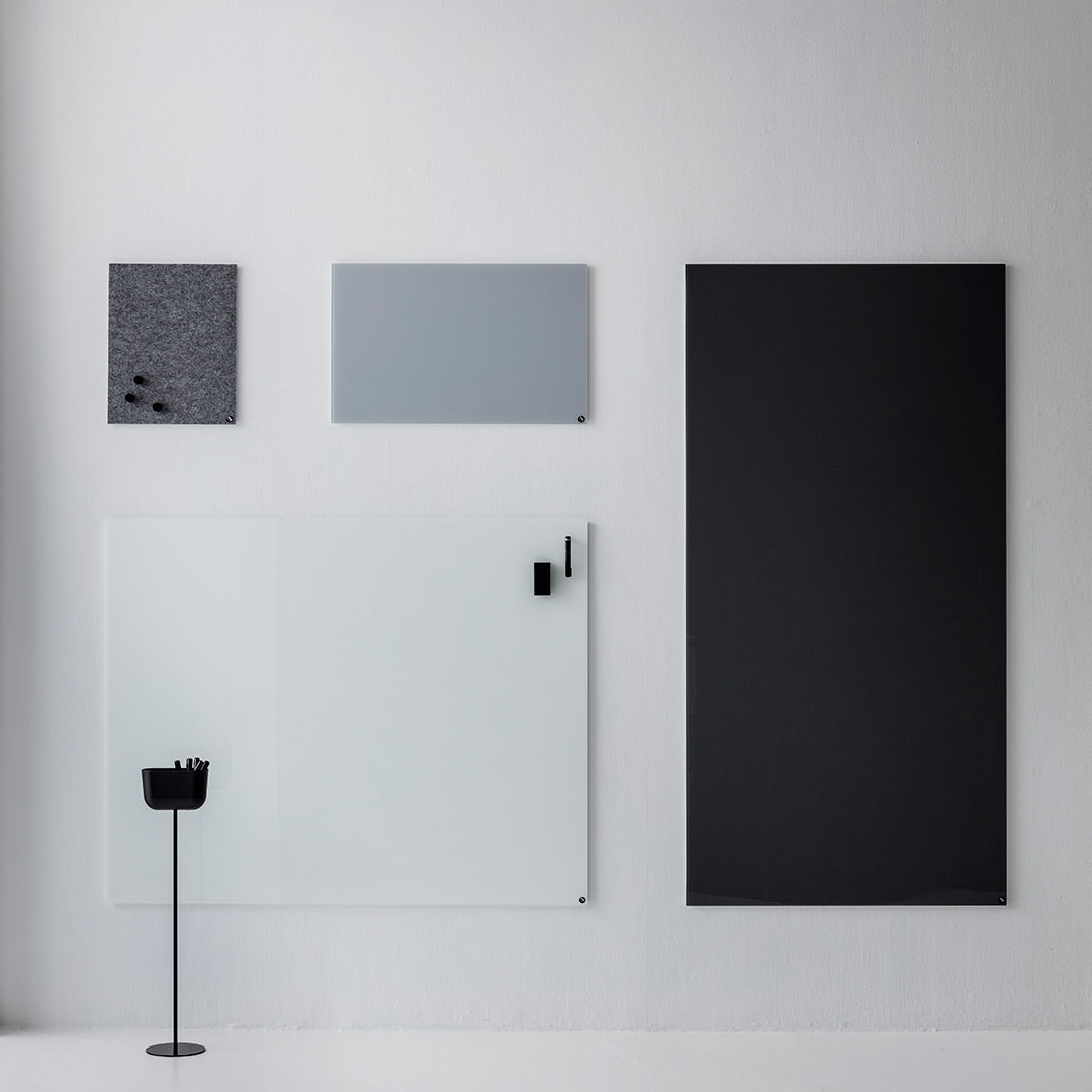Modern wall art display featuring shades of black, grey, and white with sleek patterns and textures.