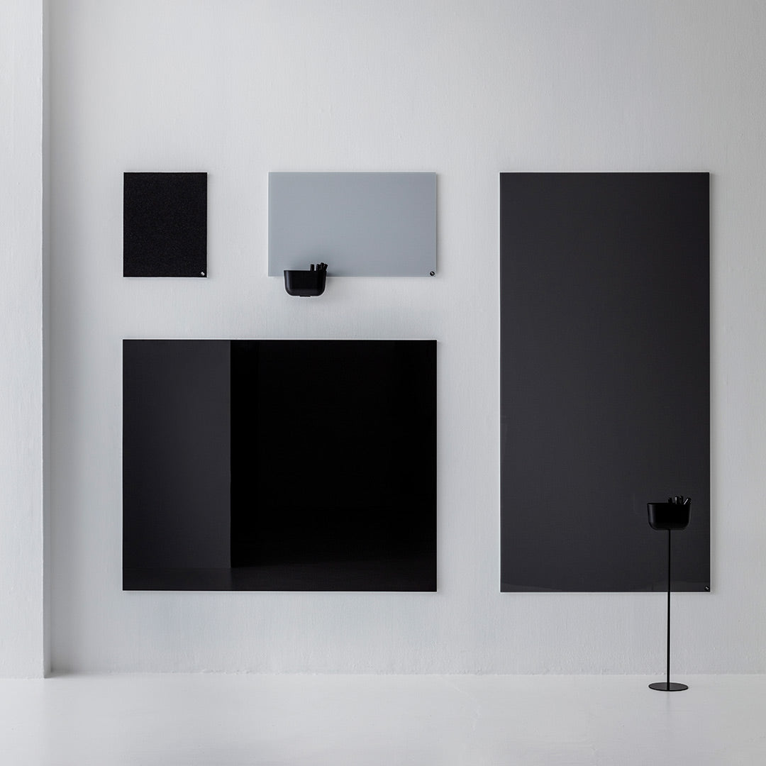Assorted black and gray wall panels with sleek, modern design and minimalistic patterns against a white background.