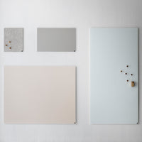 Set of minimalist boards in soft gray, light beige, and pale blue with subtle texture and natural wood accents.