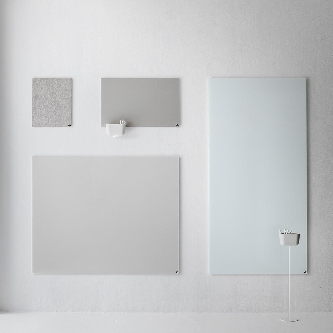 "Collection of gray wall panels with textured and smooth finishes, featuring various shapes and sizes against a pale backdrop."