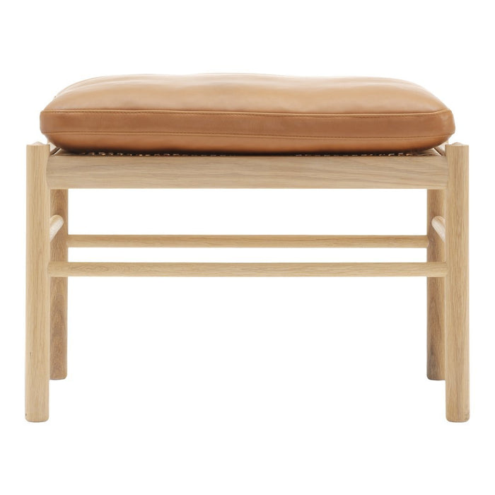 Natural wood bench with a tan leather cushion, featuring a minimalist design and smooth textures.