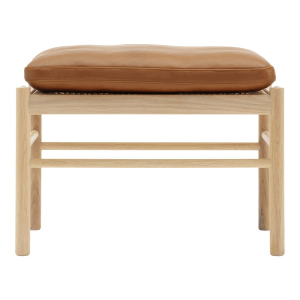 Light wood frame with a simple design, featuring a tan leather cushion for a modern, minimalist look.