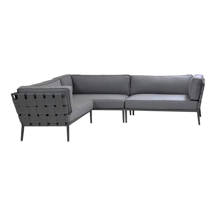 Gray sectional sofa with sleek lines and a modern geometric pattern. Perfect for contemporary outdoor or indoor spaces.