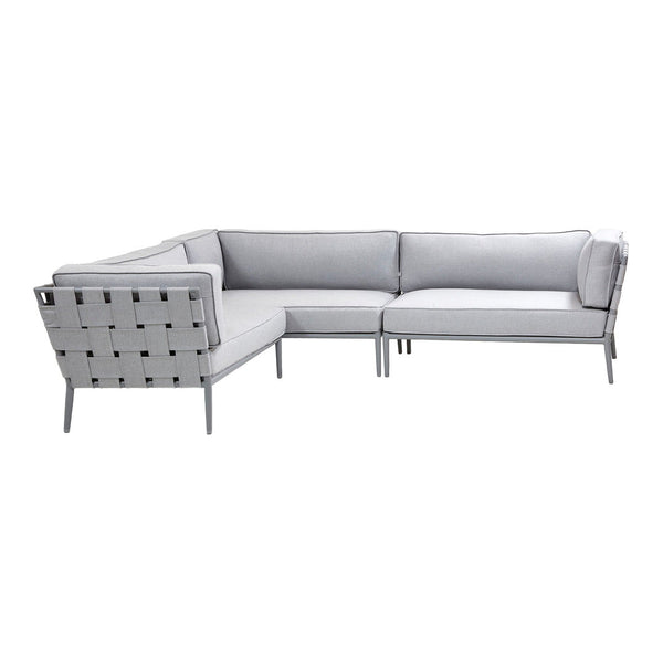 Modern gray sectional sofa with sleek lines and subtle tufted fabric pattern, perfect for contemporary spaces.