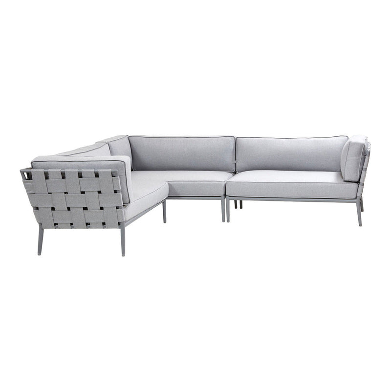 Modern gray sectional sofa with sleek lines and subtle tufted fabric pattern, perfect for contemporary spaces.