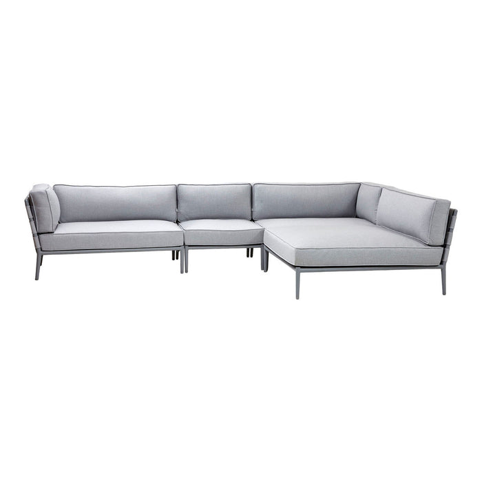 Modern sectional sofa in soft grey with sleek silver frame, featuring clean lines and minimalist design.