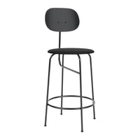 Black metal bar stool with a minimalist design, featuring a round seat and smooth backrest. Perfect for modern decor.