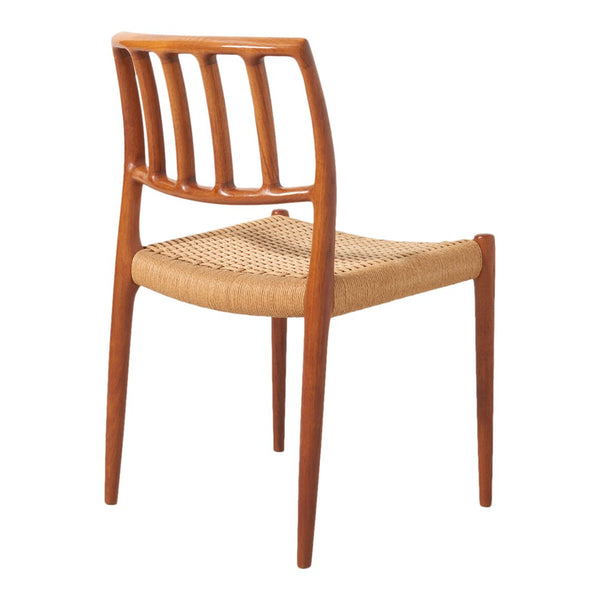 Mid-century style wooden chair with a rich walnut finish and woven natural fiber seat, featuring sleek vertical slats.