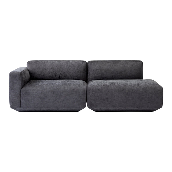 Modern dark gray sectional sofa with a minimalist design, featuring a soft velvet texture and smooth lines.