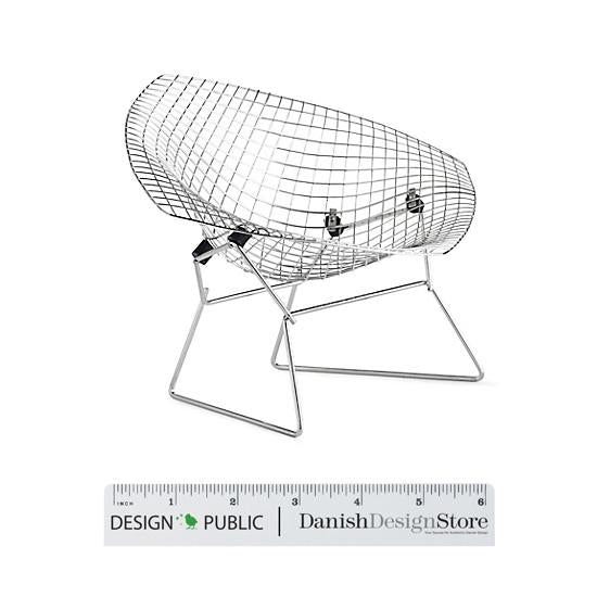 "Modern wire chair in chrome finish with a minimalist design, featuring a sleek, curved silhouette."