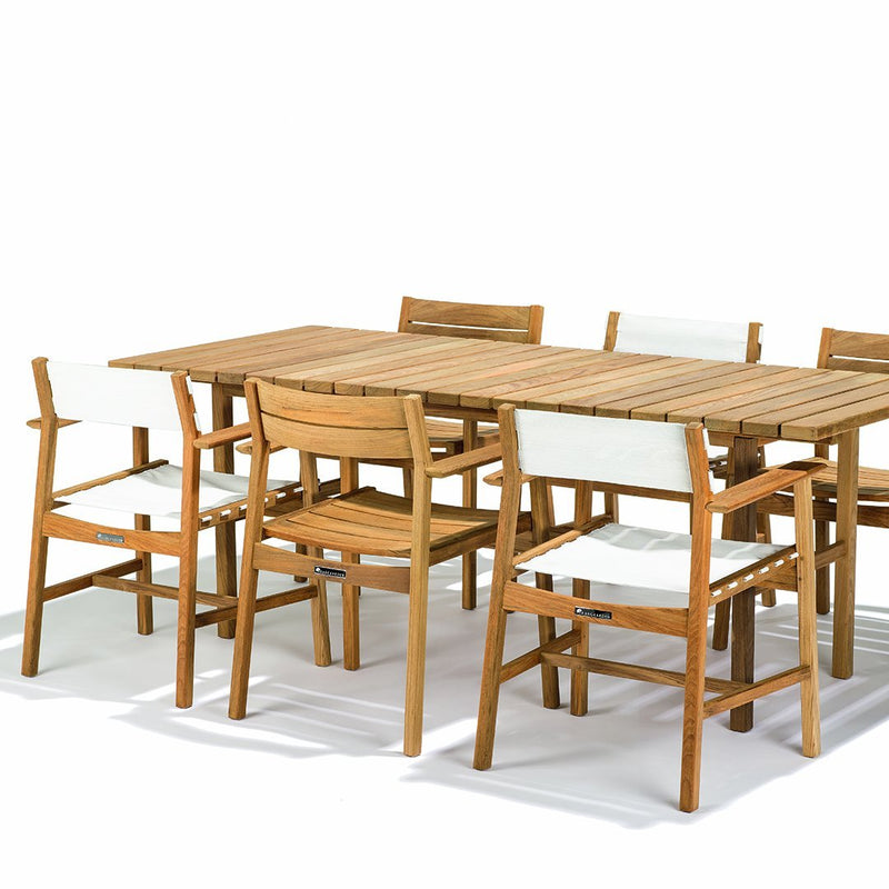 Natural wood table with six matching light-colored chairs featuring simple, clean lines for a modern look.