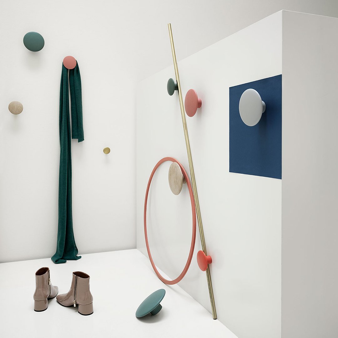 Colorful wall decor featuring green, pink, beige, and blue accents with geometric patterns and textures.