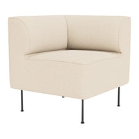 Beige corner chair with a minimalist design and subtle texture, supported by sleek black metal legs.