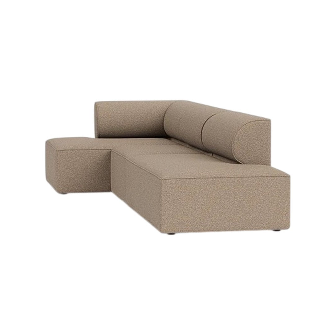 Tan sectional sofa with a textured, speckled fabric pattern, featuring a modern, minimalist design.