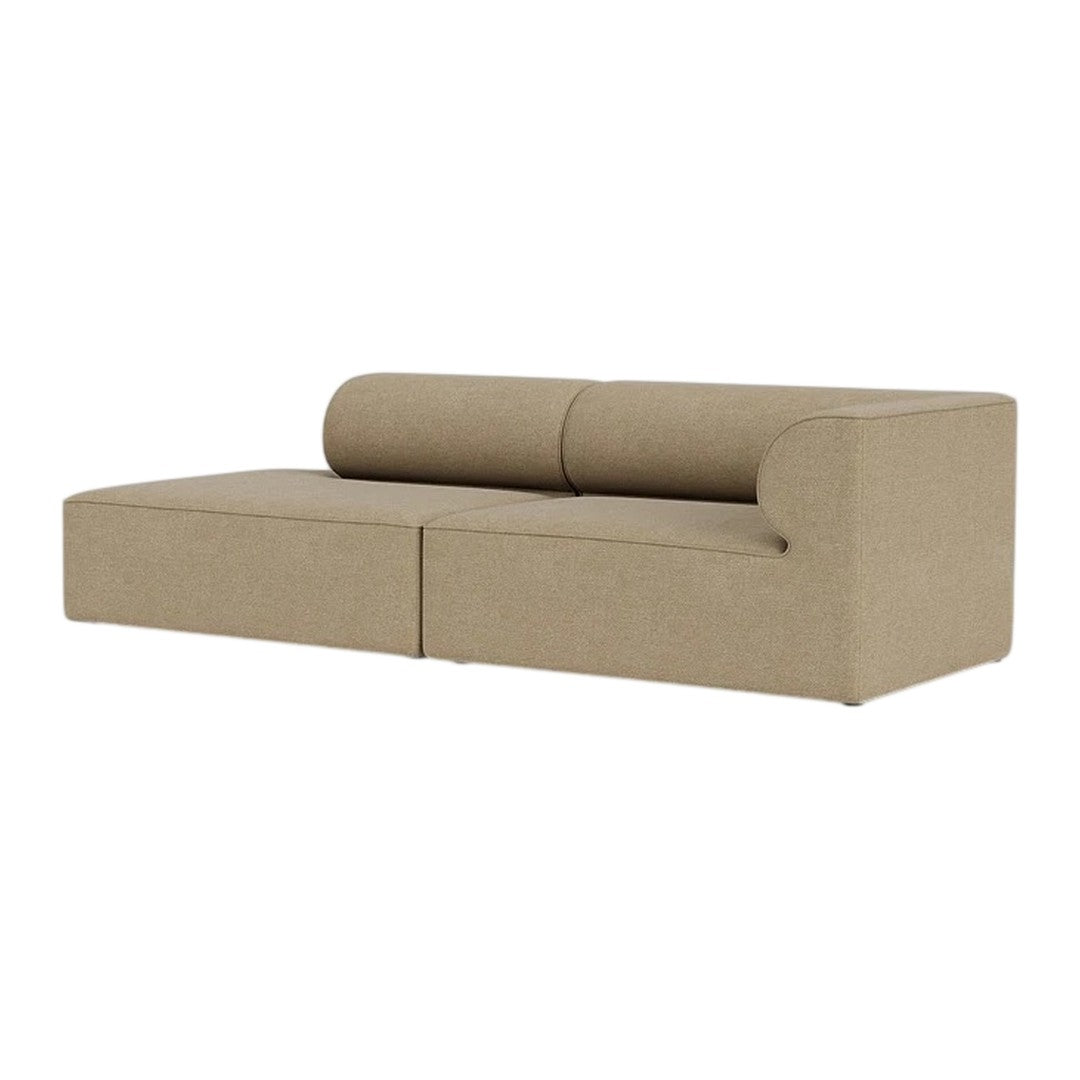 Sofa in warm beige fabric, featuring a smooth texture and modern, minimalistic design with rounded backrest.