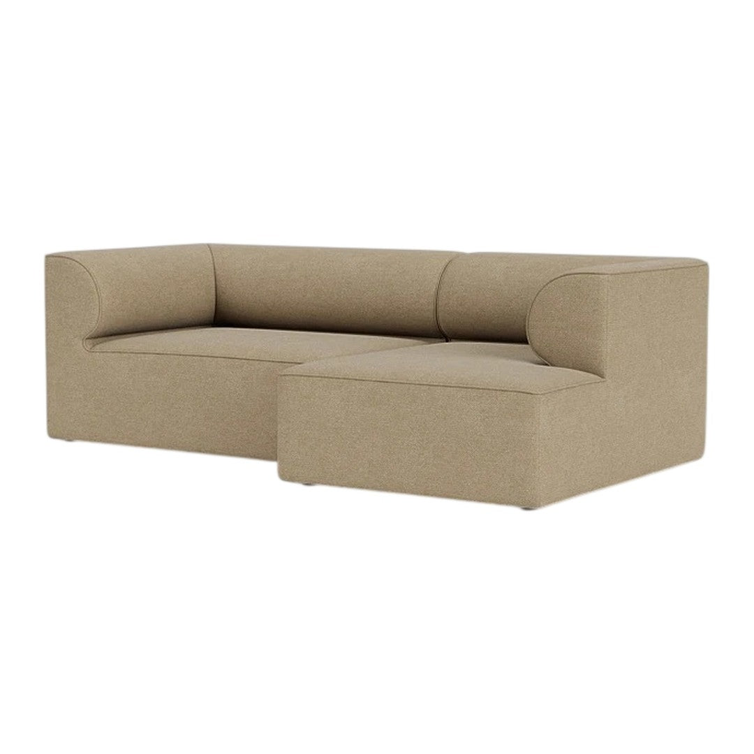 Tan L-shaped sofa with a smooth, textured fabric, featuring a minimalist design and subtle, seamless upholstery.