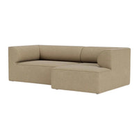 Tan L-shaped sofa with a smooth, textured fabric, featuring a minimalist design and subtle, seamless upholstery.