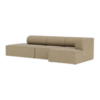 Beige sectional sofa with a smooth, textured fabric and rounded back cushions, showcasing a minimalist design.