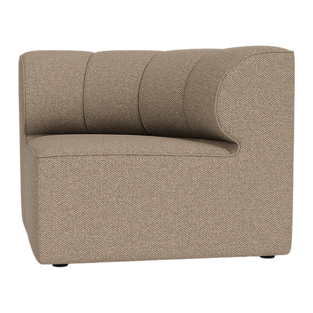 "Contemporary curved chair in a smooth beige fabric with subtle texture and plush, horizontal stitching details."