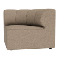 "Contemporary curved chair in a smooth beige fabric with subtle texture and plush, horizontal stitching details."