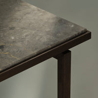 Gray marble tabletop with subtle veining and gold accents, framed by a sleek dark wood base.