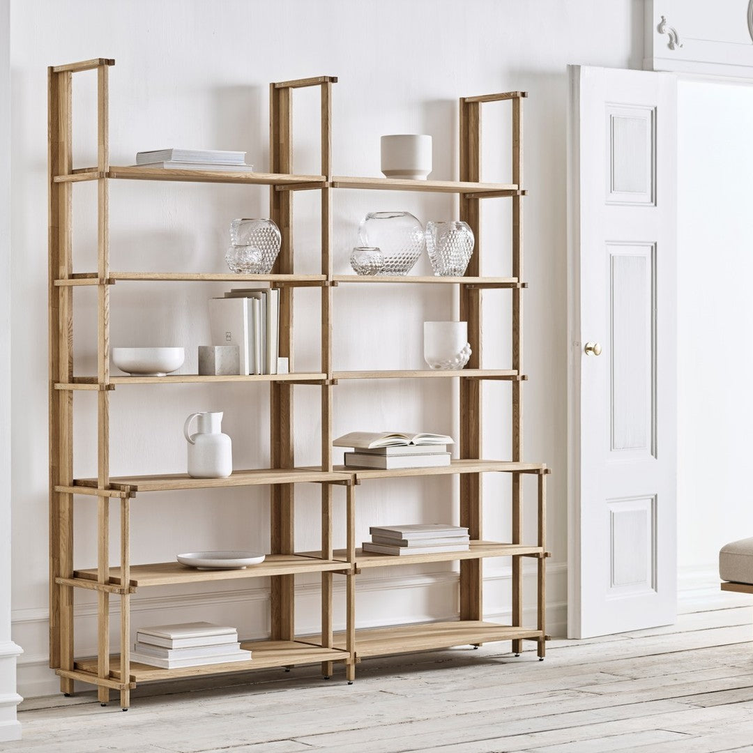 Light wood shelving unit with sleek lines and open design, featuring natural finishes and geometric patterns.