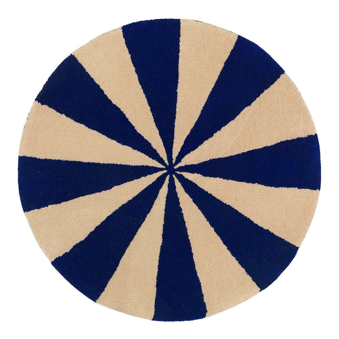 Round rug featuring navy blue and beige pattern with alternating stripes, creating a vibrant, eye-catching design.