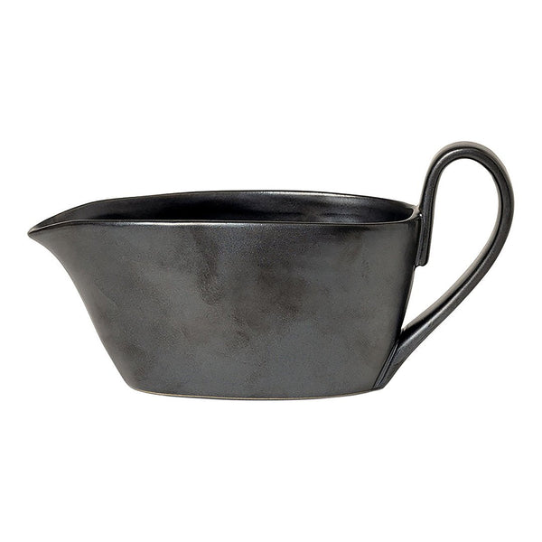 Black ceramic gravy boat with a smooth, matte finish and elegant curved handle.
