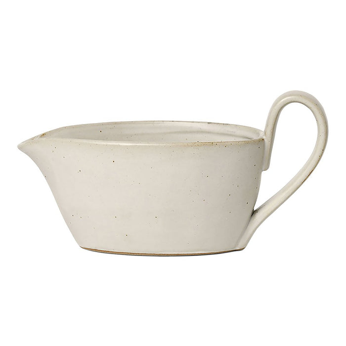 White ceramic gravy boat with a smooth matte finish and subtle speckled texture.