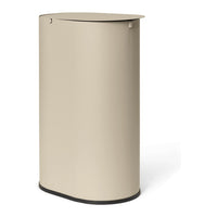 Sleek beige trash can with a smooth surface and subtle curves, featuring a contrasting black base.