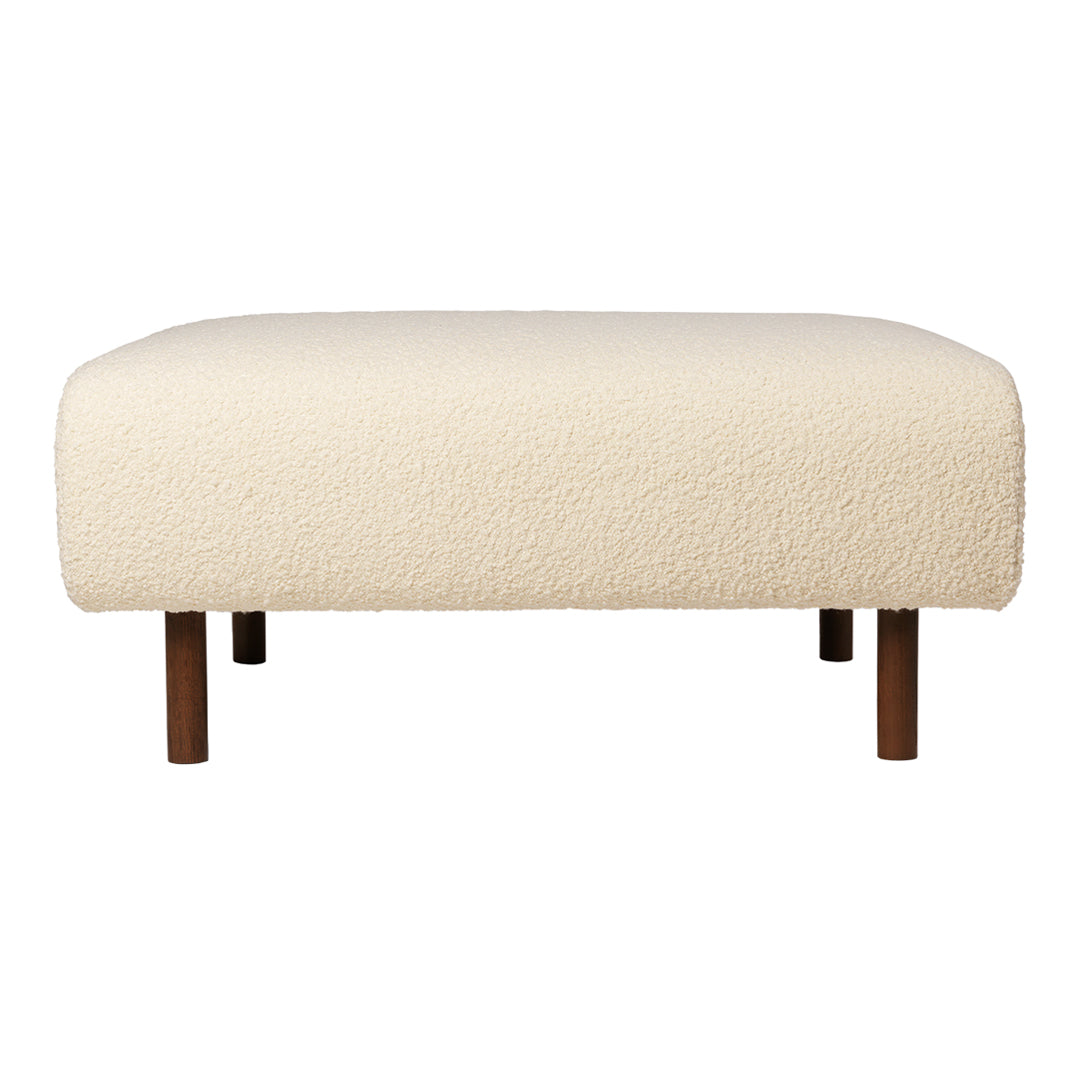 Cream-colored ottoman with a textured, fluffy fabric and wooden legs, perfect for modern decor.