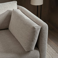 Textured light beige sofa with a minimalist design and matching rectangular cushion. Ideal for modern interiors.