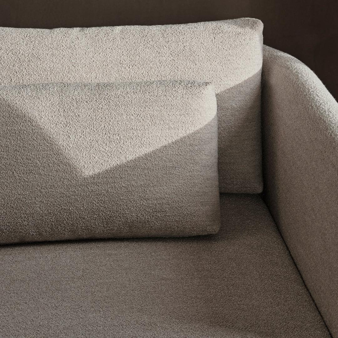 Light beige textured upholstery on a modern sofa with soft, rounded edges and minimalist design.
