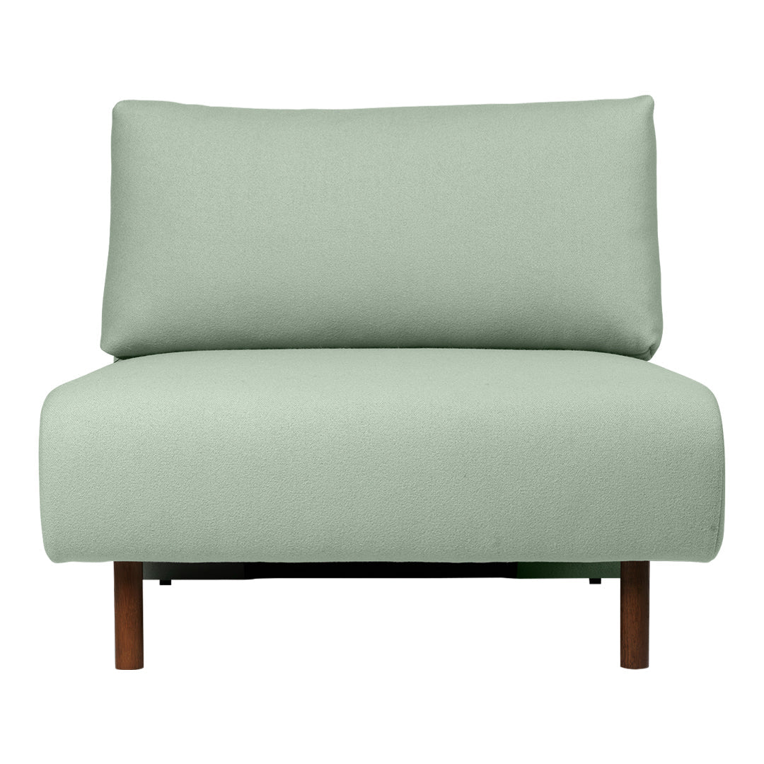 Light mint green upholstery on a contemporary chair with a simple, modern design and wooden legs.