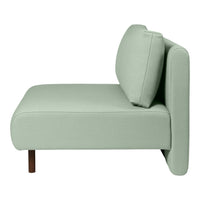 Light mint green upholstered modern sofa with a sleek design and wooden legs. Simple and stylish home decor piece.