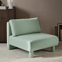 Mint green upholstered chair with a minimalist design and soft, smooth texture, featuring a matching cushion.