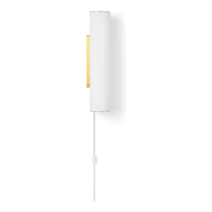 White ribbed lamp with gold accents and a white cord, showcasing a sleek and modern design.