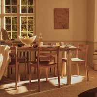 "Warm beige tones with natural wood accents and a minimalist design in a cozy dining room setting."