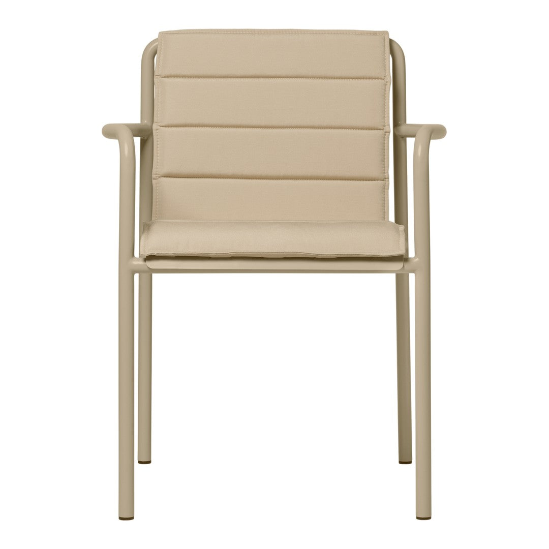 Beige armchair with a sleek, ribbed pattern and minimalist design, featuring a sturdy metal frame.