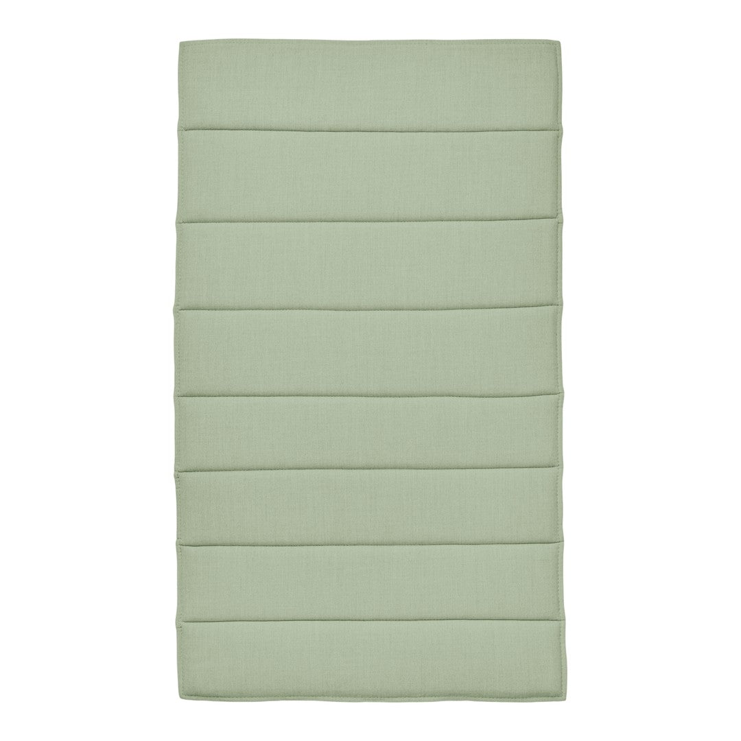 Light green padded mat with subtle vertical stripes and a smooth texture, perfect for home decor.