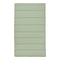 Light green padded mat with subtle vertical stripes and a smooth texture, perfect for home decor.
