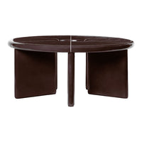 Round coffee table in deep brown with sleek, smooth finish and minimalist design featuring geometric cutouts.