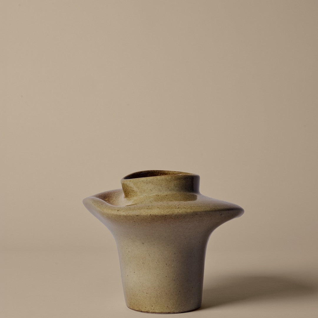 Beige ceramic vase with smooth, rounded shape and subtle matte finish. Simple and modern design perfect for decor.